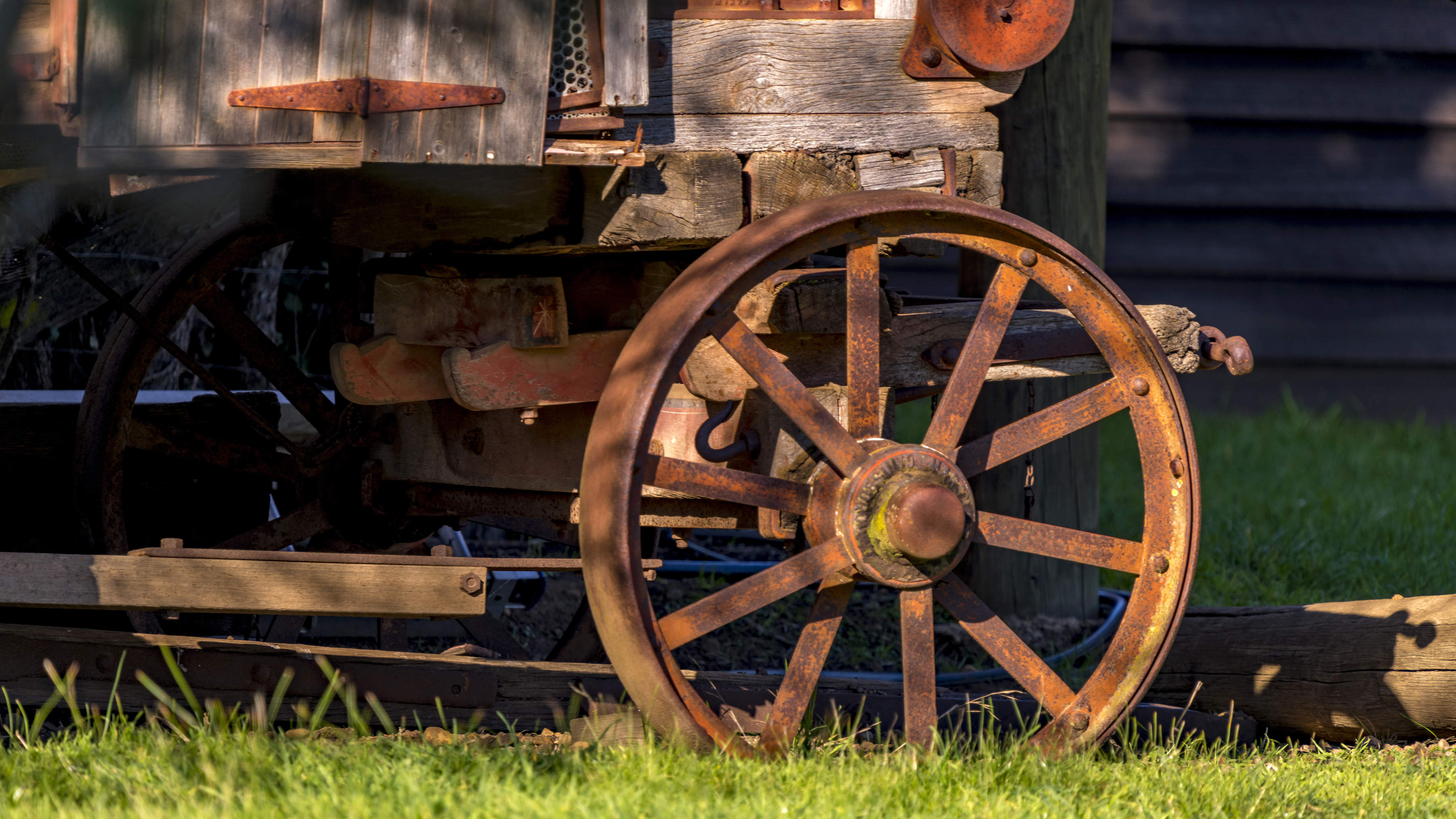 A steel spoked wheel and timber panelling are part of a Threshing machine that was used for harvesting grain. Circa 1900. Photo: Rob Burnett.