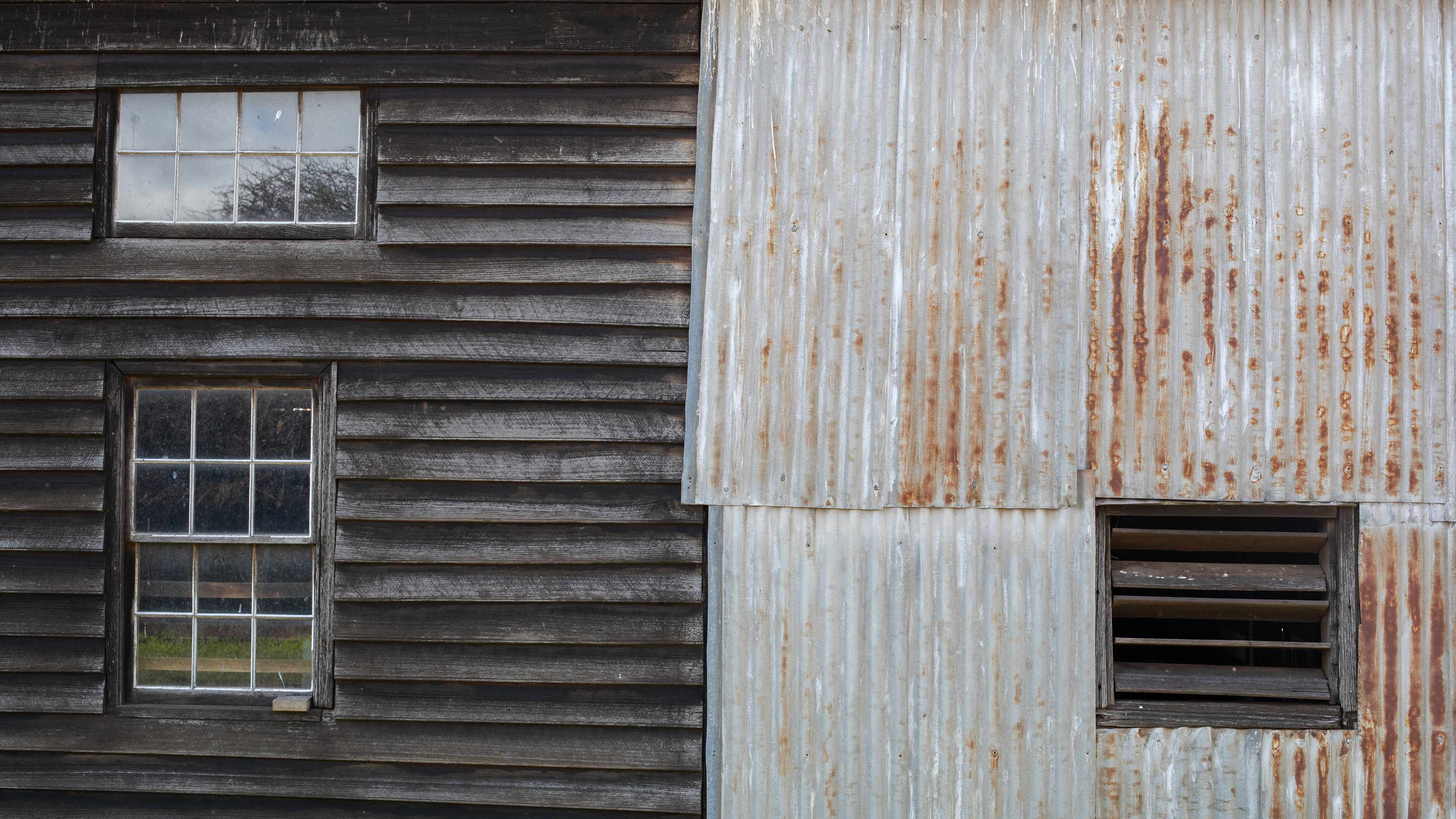 External walls of original shearing shed circa 1830 featuring horizontal weatherboards and aged corrugated iron with timber slat window. Photo: Kieran Bradley.